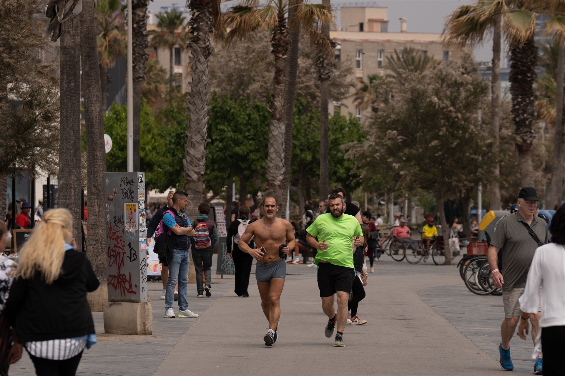 Dues persones corren sota la calor d'estiu a la Barceloneta / Europa Press
