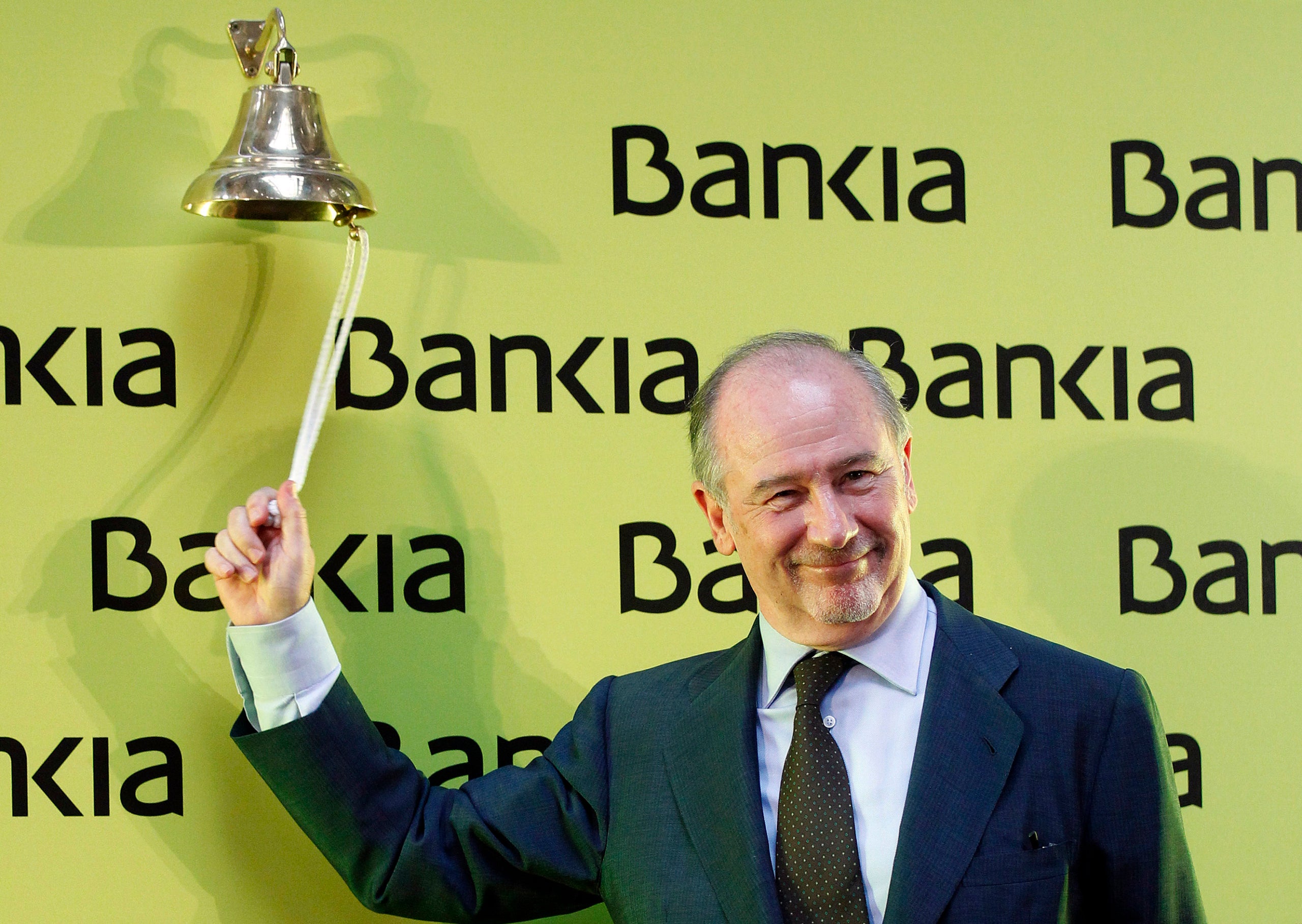 Rodrigo Rato, chairman of Spanish savings bank Bankia, rings a bell during its bourse debut in Madrid July 20, 2011. Shares in Bankia made a tepid bourse debut on Wednesday, opening below a deeply-discounted 3.75 euros initial public offering price and sliding further.
 Bankia, formed from the merger of seven regional banks, raised 3.1 billion euros ($4.4 billion) on Monday when it slashed its IPO price to 3.75 euros at the 11th hour to attract investors amid a spiralling euro zone debt crisis. REUTERS/Andrea Comas (SPAIN - Tags: BUSINESS)